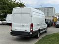 A white 2017 Ford Transit van is parked with its rear view facing the camera showcasing its cargo capacity and design features