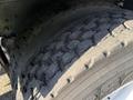 Close-up of a worn tire from a 2011 International 7500 showing significant tread wear and surface cracks