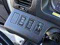 Control panel of a 2015 Hino 358 featuring buttons for setting and resuming functions along with a dial for illumination adjustment