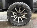 A close-up of a black and silver alloy wheel with a rugged tire labeled Ridge Grappler on a 2022 GMC Sierra 3500HD