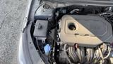 Close-up view of the engine compartment of a 2018 Hyundai Sonata showcasing the engine block and various components including the coolant reservoir and other engine parts