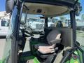 Interior view of a 2016 John Deere 1585 Terrain Cut with a cloth seat and controls visible inside the cabin