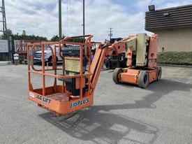 A 2009 JLG E300AJP aerial work platform with a protruding boom and basket designed for elevated work tasks