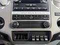 Dashboard controls of a 2012 Ford F-550 featuring climate control dials and various buttons for accessory functions