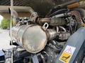 Close-up of a 2020 Hyundai HR110C engine featuring exhaust components and various pipes connected to the engine block