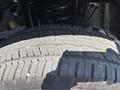 The image shows a close-up of a 2023 Ford F-350 SD tire with a detailed tread pattern and visible wear on the rubber surface
