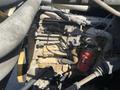 A close-up view of the engine of a 1996 GMC Top Kick featuring various metal components hoses and a red fuel filter