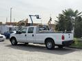 A white 2011 Ford F-350 SD with a bed liner and rear step bumper parked on a lot
