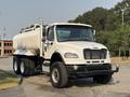 A 2016 Freightliner M2 106 truck with a large tank on the back and dual rear wheels designed for hauling liquids or materials