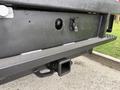 A close-up view of the rear bumper of a 2020 Ford F-550 featuring a tow hitch and connection points