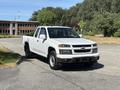 A white 2011 Chevrolet Colorado parked at an angle with a two-door cab and a truck bed visible in the image