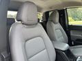 Two front seats of a 2017 Chevrolet Colorado with gray upholstery and adjustable headrests