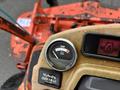 Dashboard display of a 2012 Kubota F3680 showing a temperature gauge and warning lights