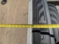 A 2019 Mercedes-Benz Sprinter with an open sliding door revealing a measuring tape laid across the floor space and interior features visible