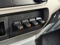 Four auxiliary switches with orange indicators on a control panel in a 2012 Ford F-550