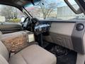 Interior of a 2008 Ford F-450 with a wooden console and a mounted device on the dashboard