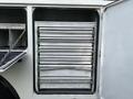 A set of metal storage shelves positioned inside a compartment of a 2013 International Durastar 4300 truck