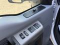 Close-up of the interior door panel of a 2014 Ford F-550 featuring window control buttons and a door lock switch