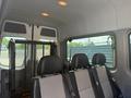Interior of a 2009 Dodge Sprinter Van showing a seating area with three black seats and a partition behind them