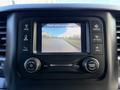 The dashboard display of a 2021 RAM 5500 showing a rearview camera image with check entire surroundings message