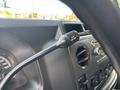 A close-up of the dashboard of a 2013 Ford E-350 Super Duty showing the speedometer and a control lever for the DVD player
