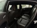 Interior of a 2017 Dodge Charger showing black leather rear seats and a spacious cabin without any passengers