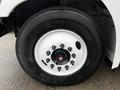 Close-up of a Hino 338 truck wheel featuring a white rim and Bridgestone tire with visible lug nuts and tread pattern