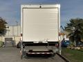 A 2022 Lion Lion6 truck viewed from the rear with a closed roll-up door and a lowered liftgate