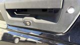 Close-up of the rear tailgate handle of a 2016 Ford F-150 showing the textured grip and keyhole for locking and unlocking the tailgate