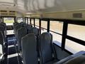 Interior view of a 2013 International CE300 school bus featuring gray seats arranged in rows with a central aisle
