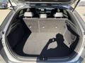 Interior view of the trunk space of a 2024 Kia Forte5 with rear seats folded down showing a spacious cargo area