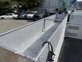 A 2006 International 4300 truck with a long flatbed featuring a diamond plate surface and a side mounted railing