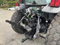 A 2009 New Holland T4020 tractor featuring large rear tires and a visible three-point hitch assembly with hydraulic controls and connectors