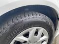 Close-up of a tire on a 2014 RAM Cargo Van showing the tread pattern and the Bridgestone logo on the sidewall
