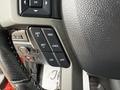 Close-up of the steering wheel controls in a 2019 Ford F-150 featuring buttons for setting cruise control and adjusting settings
