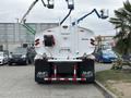 A 2025 Peterbilt 536 truck with a large tank and hose reel visible at the rear featuring the AMG logo