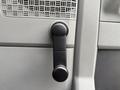 Close-up of a black manual window crank handle on a 2022 Ford E-450 door panel
