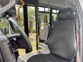 Interior view of a 2020 Chevrolet Express showing the driver's seat and steering wheel with controls visible