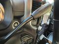 Close-up view of the interior dashboard of a 2023 RAM 3500 featuring a steering wheel knob and a touchscreen display with buttons and controls
