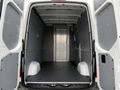 Interior view of a 2023 Mercedes-Benz Sprinter van showing the cargo area with a flat floor and side walls without any cargo or shelving