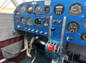 Cockpit of a 1986 Sorrell Hiperbipe SNS-7 with various gauges switches and controls including fuel pressure tachometer and throttle lever
