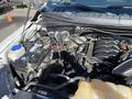 A 2018 Ford F-150 engine bay showcasing the battery and various engine components