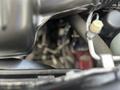 Close-up view of the engine compartment of a 2015 Jeep Grand Cherokee showing various mechanical components and hoses