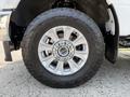 A close-up view of a 2020 Ford F-350 SD tire showcasing a chrome alloy wheel with five spokes and a rugged all-terrain tire design