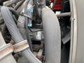 Close-up of the engine components of a 2014 International Durastar including hoses wires and metal parts