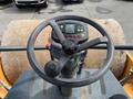 View from above of the steering wheel and control panel of a 2020 Hyundai HR110C roller with buttons and display for operating functions