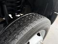 Close-up of a wet tire from a 2020 Ford F-550 showcasing deep treads and a metallic wheel design