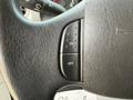 Close-up of a steering wheel button panel with an "ON" and "OFF" switch on a textured black surface