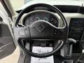 Steering wheel and dashboard of a 2012 International TerraStar with gauges control buttons and a gear shifter visible