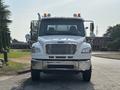 A 2010 Freightliner M2 106 truck facing forward with clear headlights and chrome accents on the front bumper and mirrors